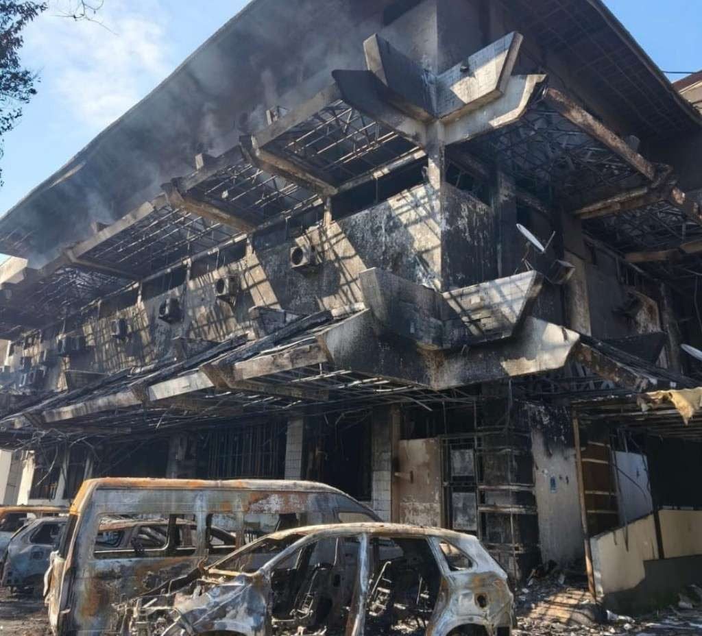 Kondisi bangunan DPRD Kota Makassar tampak hangus terbakar bersama sejumlah kendaraan di area parkir usai kericuhan massa pada Jumat malam (29/8/2025). (Foto: Int WAG DPRD Makassar)